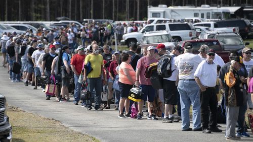 FILE - Hundreds of race fans wait in line to purchase tickets at the Ace Speedway in the rural Alamance County community of Altamahaw near Elon, N.C., on May 23, 2020. (Robert Willett/The News & Observer via AP, File)