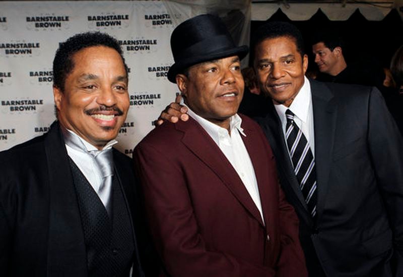 Tito Jackson, surrounded by his brothers Marlon and Jackie Jackson at a gala.