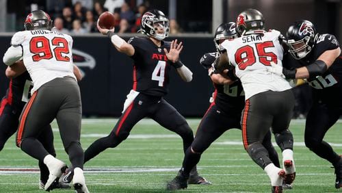  Falcons quarterback Desmond Ridder looks to pass during the first half of an NFL football game against the Tampa Bay Buccaneers on Sunday, January 8, 2023, in Atlanta.  
 Miguel Martinez / miguel.martinezjimenez@ajc.com