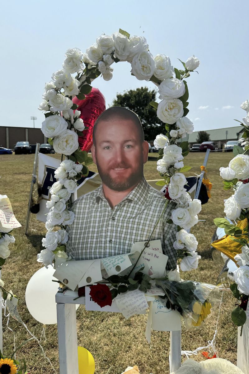 A poster with an image of shooting victim Richard Aspinwall is displayed at a memorial outside Apalachee High School, Tuesday, Sept. 10, 2024, in Winder, Ga. (AP Photo/Charlotte Kramon)