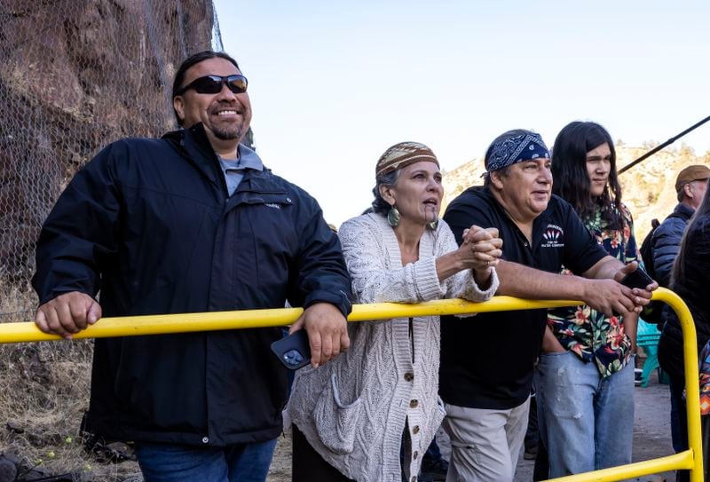 FILE - From left, Kenneth Brink, Lisa Hillman, Leaf Hillman, and Chaas Hillman, members of the Karuk Tribe, take in the moment as construction crews removed the final cofferdam that was left of Iron Gate Dam allowing the Klamath River to run in its original path near Hornbrook, Calif., Aug. 28, 2024. (Carlos Avila Gonzalez/San Francisco Chronicle via AP, File)