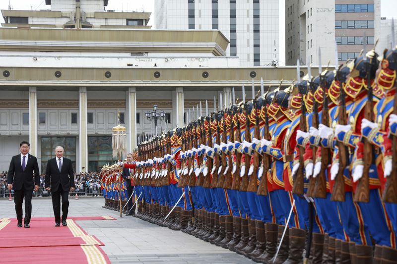 Russian President Vladimir Putin and Mongolian President Ukhnaagiin Khurelsukh, left, attend a welcome ceremony in Sukhbaatar Square in Ulaanbaatar, Mongolia, Tuesday, Sept. 3, 2024. (Vyacheslav Prokofyev, Sputnik, Kremlin Pool Photo via AP)