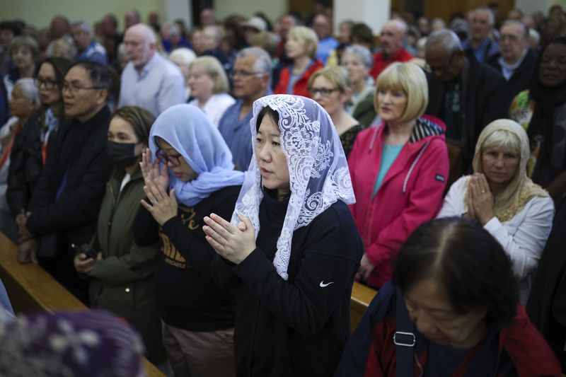 Pilgrims say their prayers inside the St. James Church in Medjugorje, Bosnia, Thursday, Sept. 19, 2024. (AP Photo/Armin Durgut)