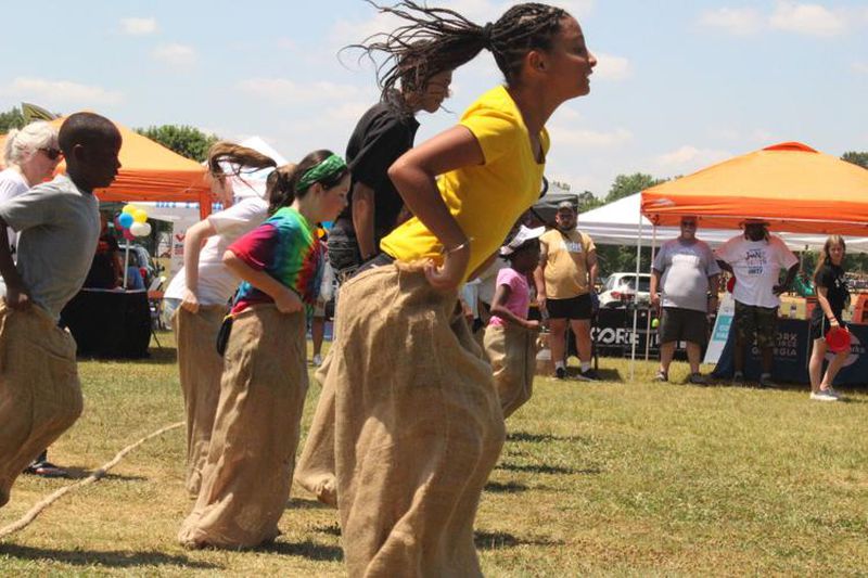 Grace Boone takes an early lead in a potato sack race at the fourth annual “Unity in the Community: A Juneteenth Celebration of Unity” event on Saturday at Swift-Cantrell Park in Kennesaw. (Photo Courtesy of Zeke Palermo)