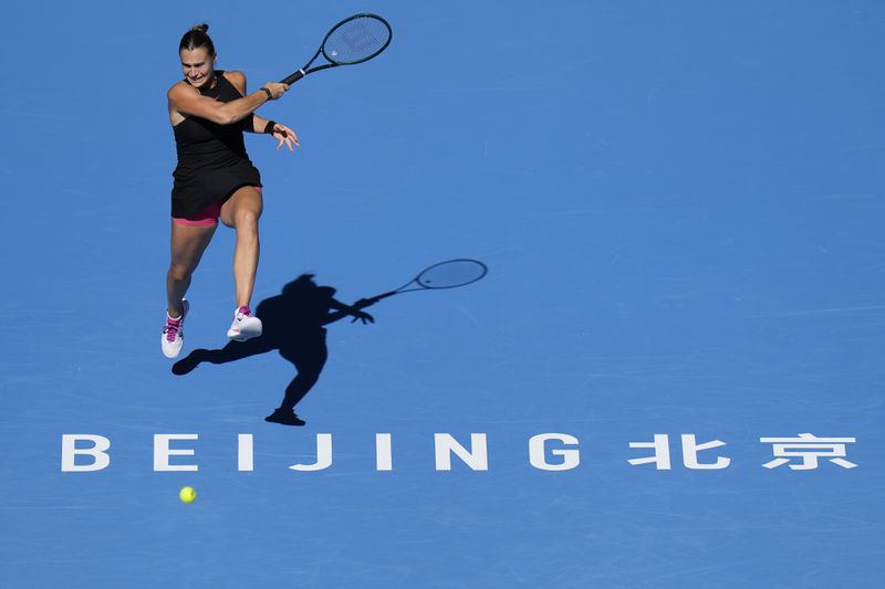 Aryna Sabalenka of Belarus plays a forehand return against Madison Keys of the United States during their women's singles match of the China Open tennis tournament, at the National Tennis Center in Beijing, Wednesday, Oct. 2, 2024. (AP Photo/Andy Wong)