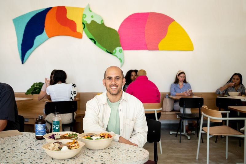Sweetgreen co-founder and co-CEO Nic Jammet helps welcome the Ponce City Market location to the chain. Each location has its own decor, and behind him is a work by Atlanta textile artist Honey Pierre, a floating tableau of organic shapes inspired by the changing seasons in the city. (Mia Yakel for The Atlanta Journal-Constitution)