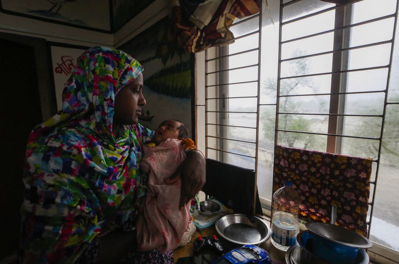 An evacuated woman and infant sit inside a shelter after Cyclone Remal lashed Bangladesh’s southern coast in Shyamnagar, Satkhira District, Bangladesh, Monday, May 27, 2024. (AP Photo/Abdul Goni)
