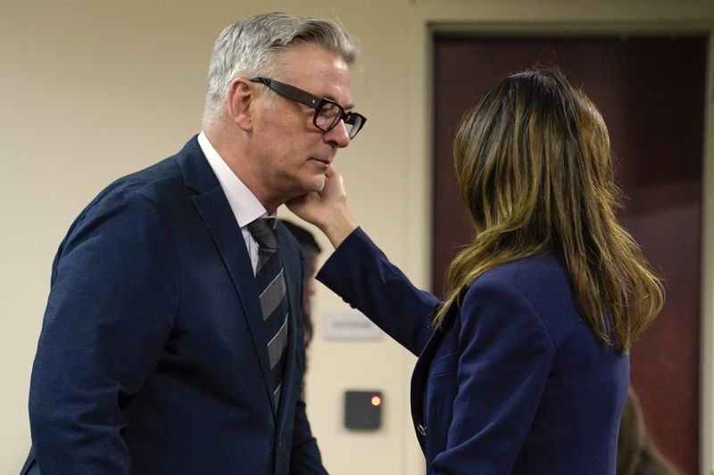 Actor Alec Baldwin approaches his wife Hilaria during his trial, Thursday, July 11, 2024, in Santa Fe, N.M. Baldwin is charged with involuntary manslaughter in the 2021 fatal shooting of cinematographer Halyna Hutchins during filming of the Western movie "Rust". (Ramsay de Give/Pool Photo via AP)