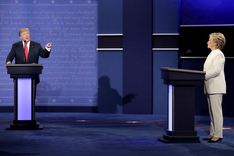 FILE - Democratic presidential nominee Hillary Clinton listens to Republican presidential nominee Donald Trump during the third presidential debate, Oct. 19, 2016. (AP Photo/David Goldman, File)