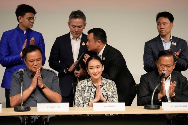 Leader of Pheu Thai Party, Paetongtarn Shinawatra, daughter of Thailand's former Prime Minister Thaksin Shinawatra, center and coalition partners gesture during press conference in Bangkok, Thailand, Thursday, Aug. 15, 2024. (AP Photo/Sakchai Lalit)