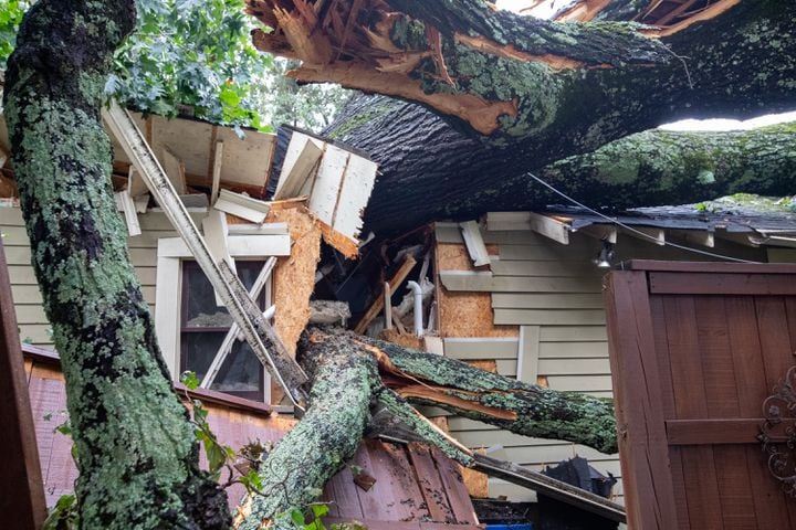 Damage from hurricane Helene includes trees down and power outages Friday, Sept 27, 2024 in Kirkwood.  Several homes were damaged in this area with multiple large oak trees falling in backyards. No one was hurt and residents are waiting for insurance adjusters to arrive.  (Jenni Girtman for The Atlanta Journal-Constitution)