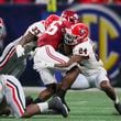 Georgia Bulldogs defensive back Malaki Starks (24) and Georgia linebacker C.J. Allen (33) tackle Alabama Crimson Tide running back Jam Miller (26) during the SEC Championship football game at the Mercedes-Benz Stadium in Atlanta, on Saturday, December 2, 2023. (Jason Getz / Jason.Getz@ajc.com)