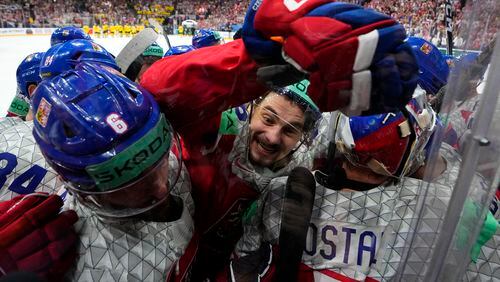 Czech Republic's David Tomasek, center, celebrates with teammates after the semifinal match between Czech Republic and Sweden at the Ice Hockey World Championships in Prague, Czech Republic, Saturday, May 25, 2024. (AP Photo/Petr David Josek)