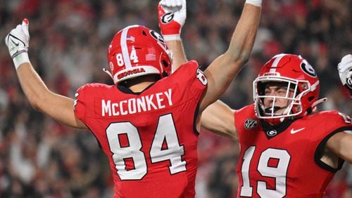 Georgia tight end Brock Bowers (right) celebrates with wide receiver Ladd McConkey celebrates with after a touchdown against Ole Miss. (Hyosub Shin/The Atlanta Journal-Constitution)