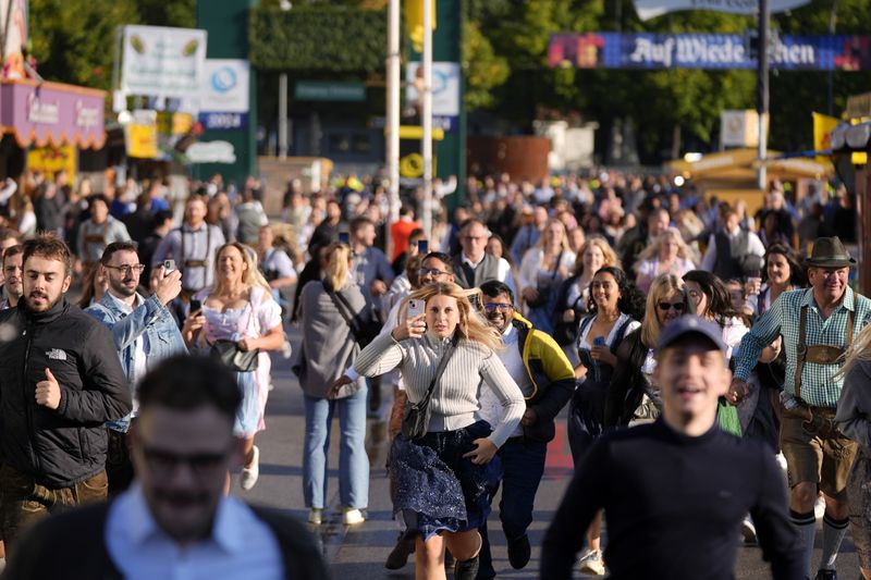 People run to enter the 189th 'Oktoberfest' beer festival in Munich, Germany, Saturday, Sept. 21, 2024. (AP Photo/Matthias Schrader)