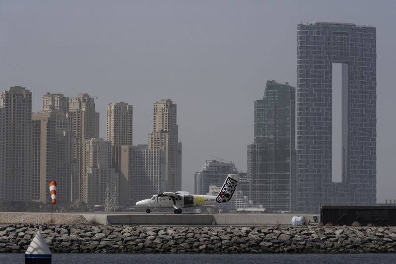 A small aircraft, carrying skydivers, is ready for take off on a runway at Dubai Harbour, United Arab Emirates, Tuesday, Aug. 13, 2024. (AP Photo/Altaf Qadri)