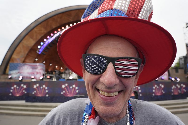 Doc Rutstein, of Braintree, Mass., poses for a photo before the Boston Pops Fireworks Spectacular at the Hatch Memorial Shell on the Esplanade in Boston, Thursday, July 4, 2024. (AP Photo/Michael Dwyer)