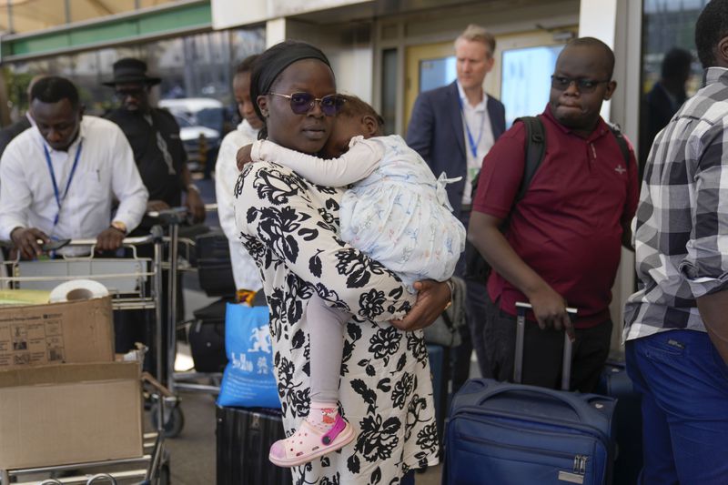 Stranded passengers wait for their delayed flights out of JKIA airport after flights were grounded following workers’ protesting a planned deal between the government and a foreign investor, in Nairobi, Kenya, Wednesday, Sept. 11, 2024. (AP Photo/Brian Inganga)