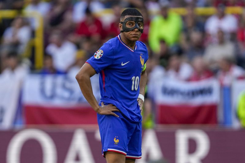 FILE - Kylian Mbappe of France during a Group D match between the France and Poland at the Euro 2024 soccer tournament in Dortmund, Germany, Tuesday, June 25, 2024. Cristiano Ronaldo vs. Kylian Mbappé is not just a clash of soccer icons but a clash of generations. They’ll go head to head when Portugal plays France in the Euro 2024 quarterfinals on Friday and their heavyweight meeting just got a little bit bigger after Ronaldo said this would be his last European Championship. (AP Photo/Darko Vojinovic, File)