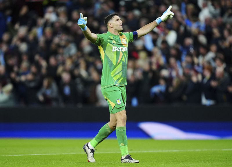 Aston Villa's goalkeeper Emiliano Martinez celebrates during the Champions League opening phase soccer match between Aston Villa and Bayern Munich, at Villa Park in Birmingham, England, Wednesday, Oct. 2, 2024. (Mike Egerton/PA via AP)