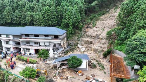 In this drone photo released by Xinhua News Agency, a landslide destroys a house in Yuelin village of Shouyue town of Hengyang city, central China's Hunan Province on Sunday, July 28, 2024. (Chen Zhenhai/Xinhua via AP)
