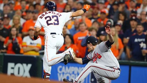 110221 HOUSTON: Braves starting and winning pitcher Max Fried falls after colliding with Astros Michael Brantley while fielding at first base in game 6 of the World Series on Tuesday, Nov. 2, 2021, in Houston.   “Curtis Compton / Curtis.Compton@ajc.com”