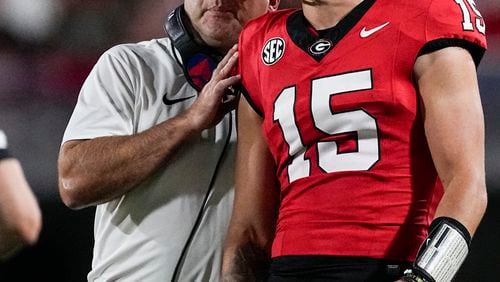 FILE - Georgia head coach Kirby Smart talks with his quarterback Carson Beck during the first half of an NCAA college football game against UAB, Saturday, Sept. 23, 2023, in Athens, Ga. (AP Photo/John Bazemore, File)