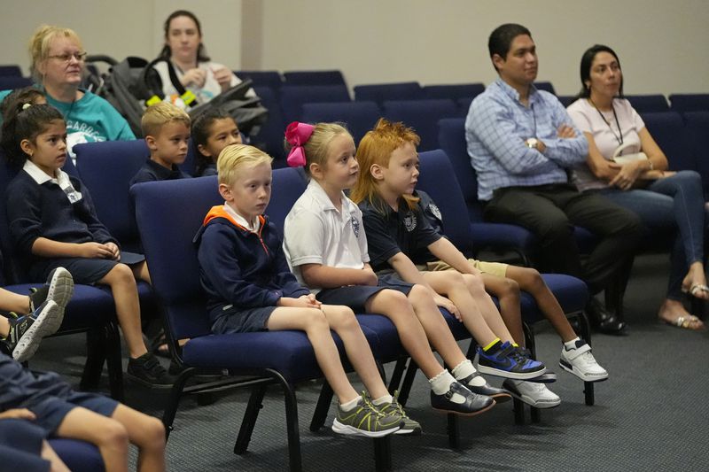 Students and parents attend a chapel service at the Winter Garden Christian Academy Thursday, Aug. 29, 2024, in Winter Garden, Fla. (AP Photo/John Raoux)