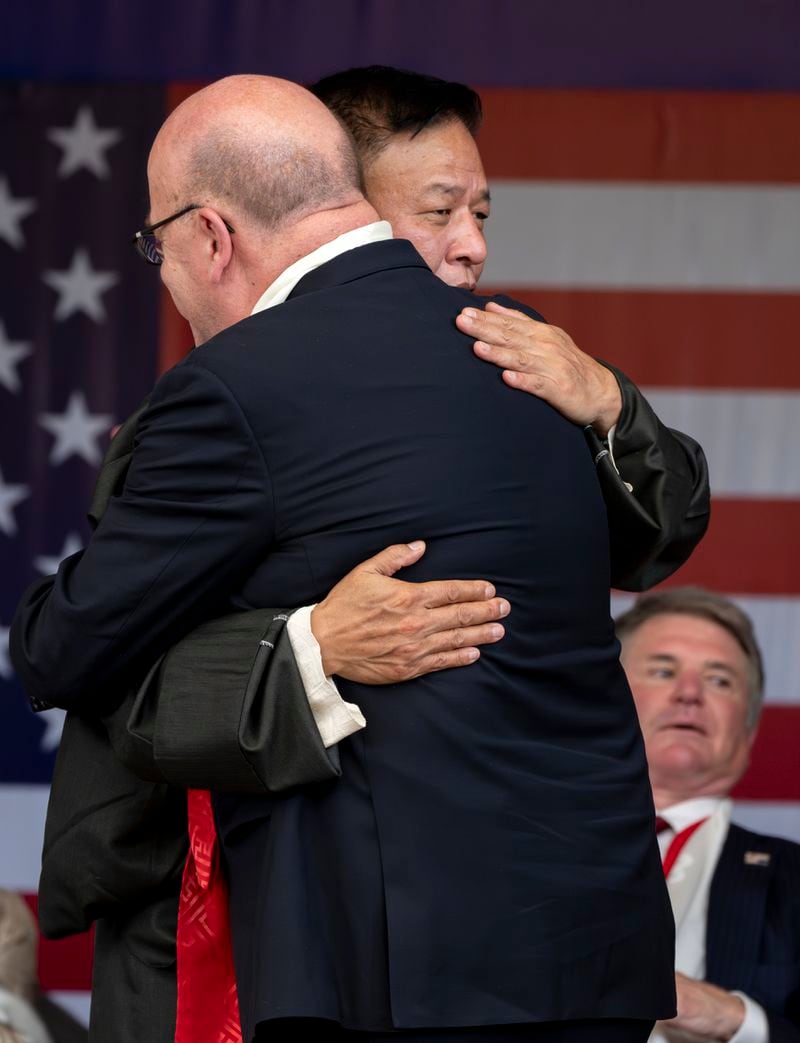 President of the Central Tibetan Administration, Penpa Tsering, hugs Democrat Rep. Jim McGovern, right, at a public event during which a US delegation led by Republican Rep. Michael McCaul, sitting behind, was felicitated by the Tibetan exiled government officials at the Tsuglakhang temple in Dharamshala, India, Wednesday, June 19, 2024. (AP Photo/Ashwini Bhatia)