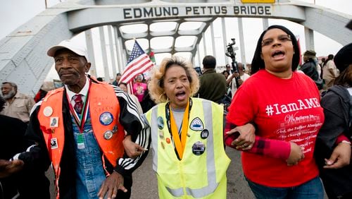 John Rankin, left, walks during the annual re-enactment of a key event in the civil rights movement in Selma, Ala., Sunday, March 5, 2017. Sunday marked the 52nd anniversary of the march across the Edmund Pettus Bridge over the Alabama River in Selma. On March 7, 1965, African-Americans seeking voting rights launched a march across the bridge en route to Montgomery but were attacked by police. That violent episode became known as "Bloody Sunday." (Albert Cesare/The Montgomery Advertiser via AP)