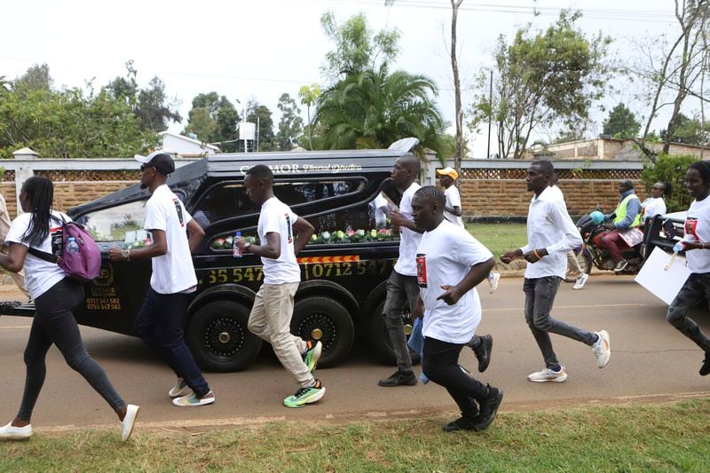 Members of the public escort a hearse carrying the coffin of Ugandan Olympic athlete Rebecca Cheptegei in the western city of Eldoret, in Rift Valley, Kenya Friday, Sept. 13, 2024. (AP Photo/Andrew Kasuku)