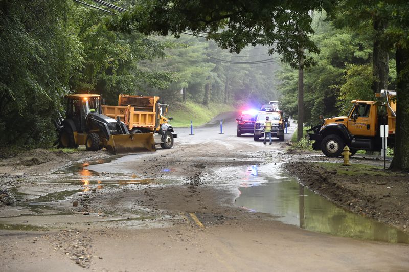 Danbury Conn., city workers clear debris from a mudslide on Shelter Rock Rd., in Danbury, Conn., Monday, Aug. 19, 2024. (H John Voorhees III/Hearst Connecticut Media)