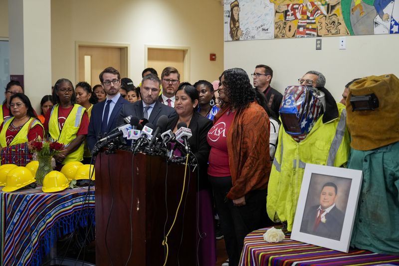 Maria del Carmen Castellón, center, the wife of Miguel Luna, a welder who died during the collapse of Baltimore's Francis Scott Key Bridge, speaks during a press conference, Tuesday, Sept. 17, 2024, in Baltimore. (AP Photo/Stephanie Scarbrough)