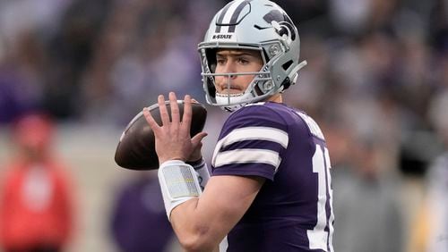 FILE - Then-0Kansas State quarterback Will Howard looks to pass during the second half of the team's NCAA college football game against Baylor, Nov. 11, 2023, in Manhattan, Kan. (AP Photo/Charlie Riedel, File)