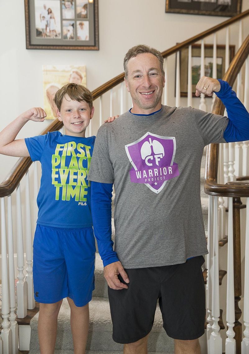 Andy Lipman and his son, Ethan, are shown at their home in Sandy Springs. Andy’s kids are aware of his treatments for cystic fibrosis. ALYSSA POINTER / ALYSSA.POINTER@AJC.COM