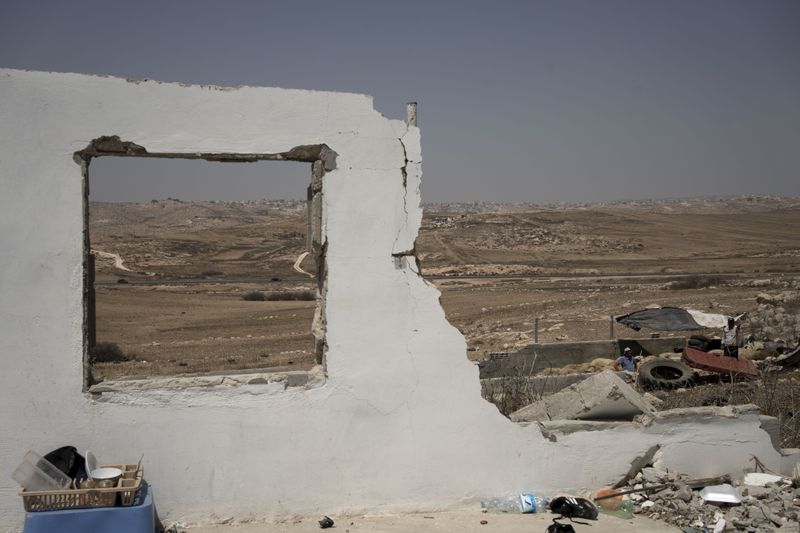 The ruins of a home in the West Bank village of Khirbet Zanuta, destroyed when residents were driven out by Israeli settlers, Tuesday, Aug. 27, 2024. Ten months after settlers threatened to kill them if they didn't leave their village, some Palestinian residents are finally home, under a rare court order. (AP Photo/Maya Alleruzzo)