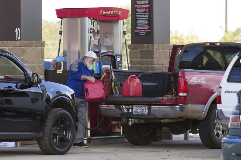 After waiting on long lines to fill up their gas tanks at the Sheetz station, people were also filling up containers of gas for their generators after Hurricane Helene caused power outages, Saturday, Sept. 28, 2024, in Morganton, N.C. (AP Photo/Kathy Kmonicek)