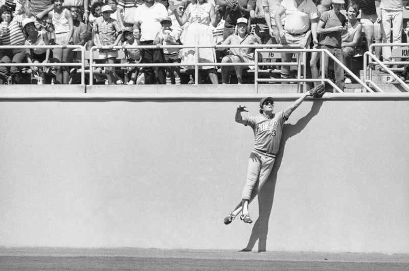 Braves center fielder Dale Murphy leaps high against the wall to make a catch in 1983. 