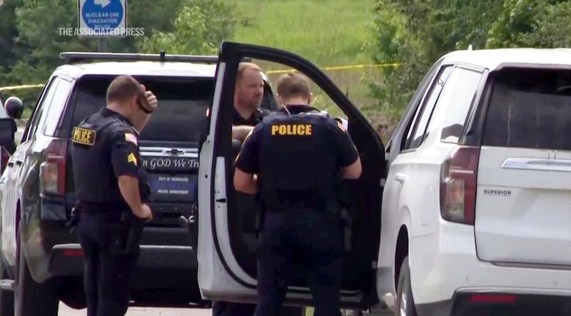 This image from video provided by KATV shows police officers at the scene where Stacy Lee Drake was taken into custody Thursday, June 20, 2024 in Morrilton, Ark. An Alabama man wanted in connection with homicides in Oklahoma and Alabama was apprehended Thursday in Arkansas after a search that spanned multiple southern states, Arkansas State Police said. (KATV via AP)