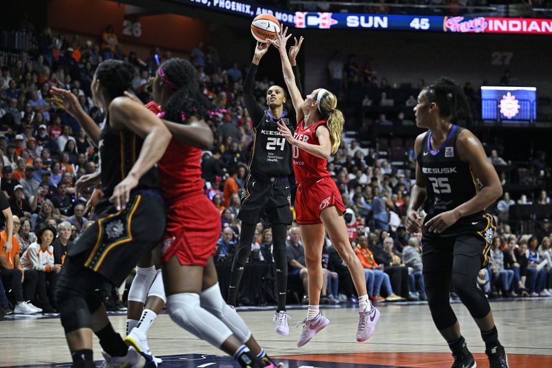 Connecticut Sun forward DeWanna Bonner (24) shoots over Indiana Fever guard Lexie Hull (10) during the second half of a first-round WNBA basketball playoff game, Wednesday, Sept. 25, 2024, in Uncasville, Conn. (AP Photo/Jessica Hill)