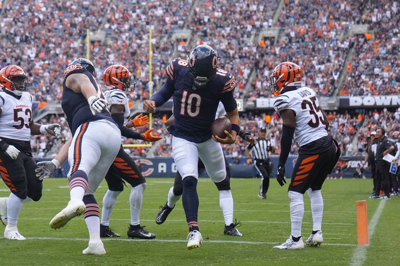 Chicago Bears quarterback Caleb Williams (18) carries the ball in for a touchdown during the first half of an NFL preseason football game against Cincinnati Bengals, Saturday, Aug. 17, 2024, at Soldier Field in Chicago. (AP Photo/Erin Hooley)