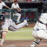 Austin Riley scores the winning run in the 11th inning of Monday's win over the Diamondbacks.