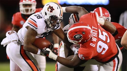 Georgia defensive tackle Devonte Wyatt tackles Auburn running back JaTarvious Whitlow during the first half in a NCAA college football game on Saturday, Nov. 10, 2018, in Athens.  Curtis Compton/ccompton@ajc.com