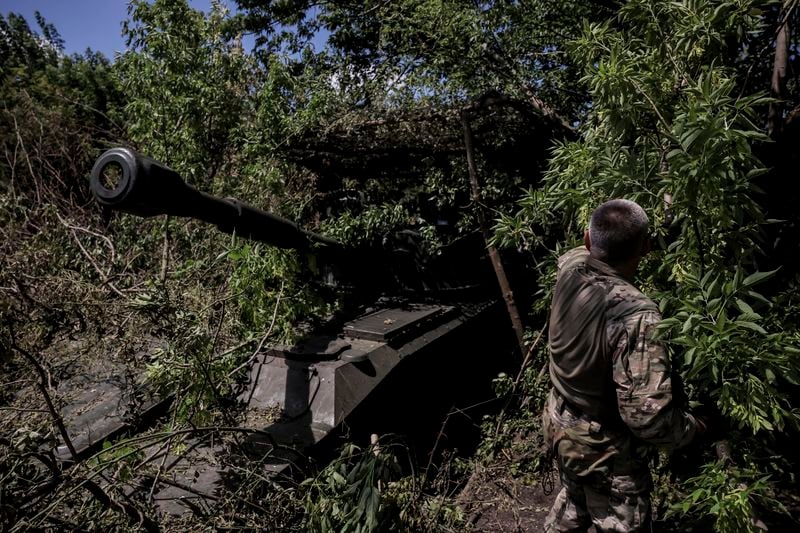 In this photo provided by Ukraine's 24th Mechanised Brigade press service, a soldier prepares to fire a "Gvozdika" 120mm Soviet-made howitzer towards Russian positions at outskirts of Chasiv Yar, Donetsk region, Ukraine, Saturday, June 22, 2024. (Oleg Petrasiuk/Ukraine's 24th Mechanised Brigade via AP)