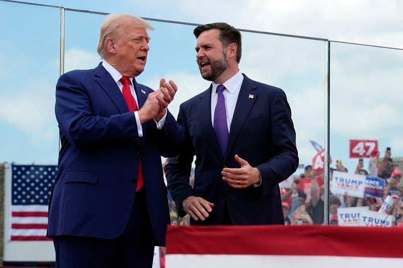 Republican presidential nominee former President Donald Trump and Republican vice presidential nominee Sen. JD Vance, R-Ohio, stand on stage at a campaign rally at North Carolina Aviation Museum, Wednesday, Aug. 21, 2024, in Asheboro, N.C. (AP Photo/Julia Nikhinson)