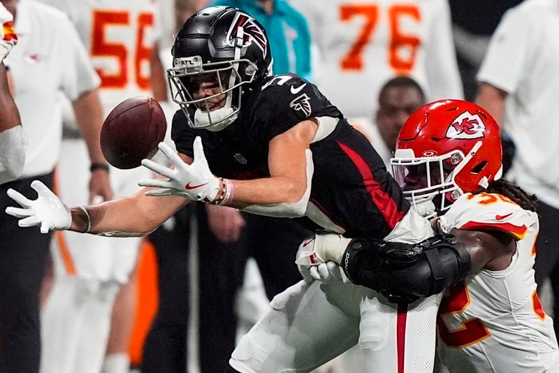 Atlanta Falcons wide receiver Drake London (5) loses the ball but recovers against Kansas City Chiefs linebacker Nick Bolton (32) during the second half of an NFL football game, Sunday, Sept. 22, 2024, in Atlanta. (AP Photo/Brynn Anderson)