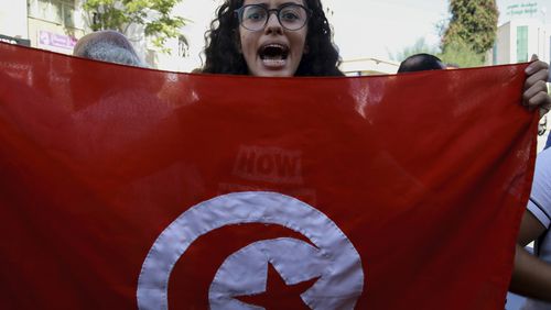 A Tunisian woman shouts slogans during a demonstration against Tunisia president Kais Saied, ahead of the upcoming presidential elections, in Tunis, Friday, Sept. 27, 2024. (AP Photo/Anis Mili)