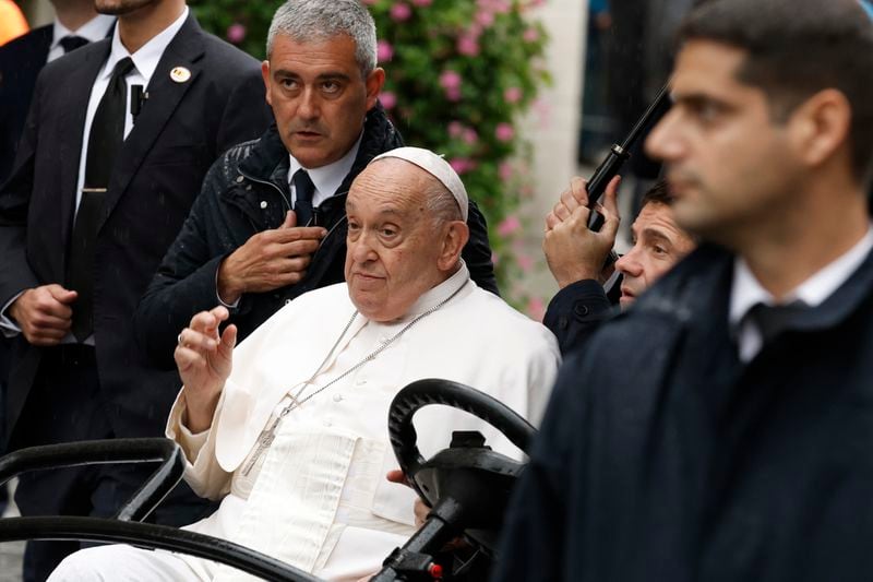 Pope Francis waves during a tours in an open car among the faithful in the Groet Markt in Leuven, Belgium, on the second day of his four-day visit to Luxembourg and Belgium, Friday, Sept. 27, 2024. (AP Photo/Omar Havana)