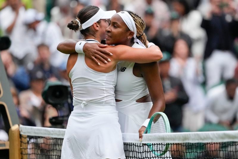 Coco Gauff, right, of the United States embraces compatriot Caroline Dolehide following their first round match of the Wimbledon tennis championships in London, Monday, July 1, 2024. (AP Photo/Alberto Pezzali)