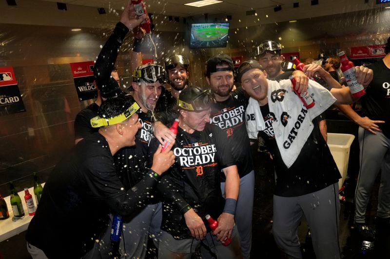 The Detroit Tigers celebrate in the clubhouse after defeating the Houston Astros in Game 2 to clinch the AL Wild Card baseball series, Wednesday, Oct. 2, 2024, in Houston. (AP Photo/Kevin M. Cox)